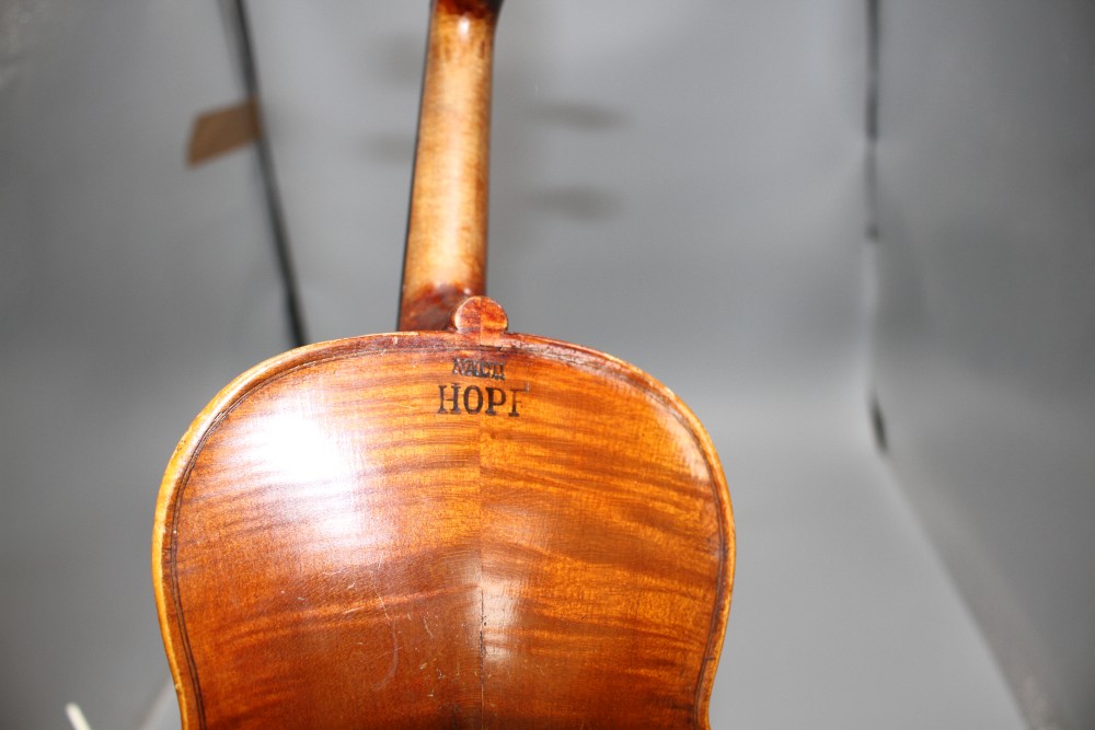 A violin with two piece back and bow, and a childs violin with bow, both with cases